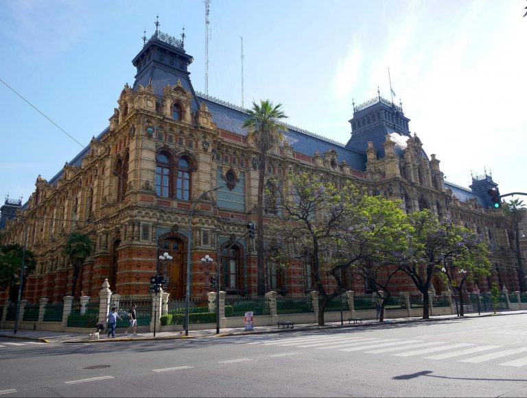 A church with a clock on the side of a road